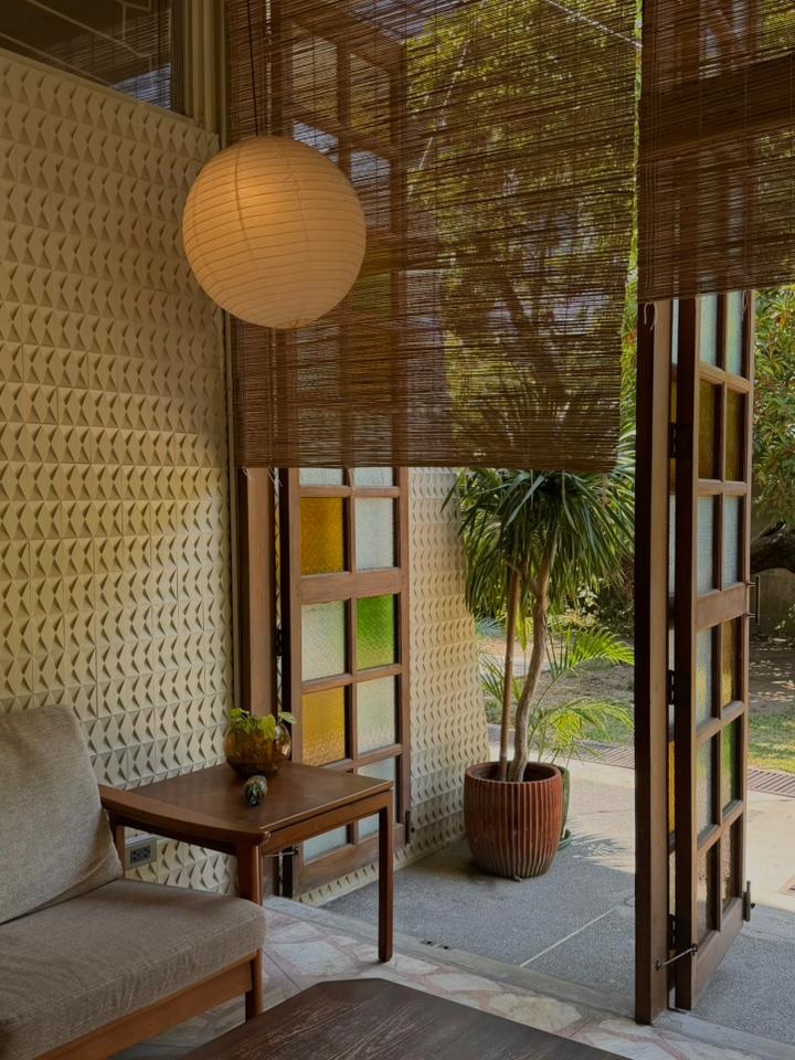 Interior space with bamboo blinds and colorful stained glass garden view